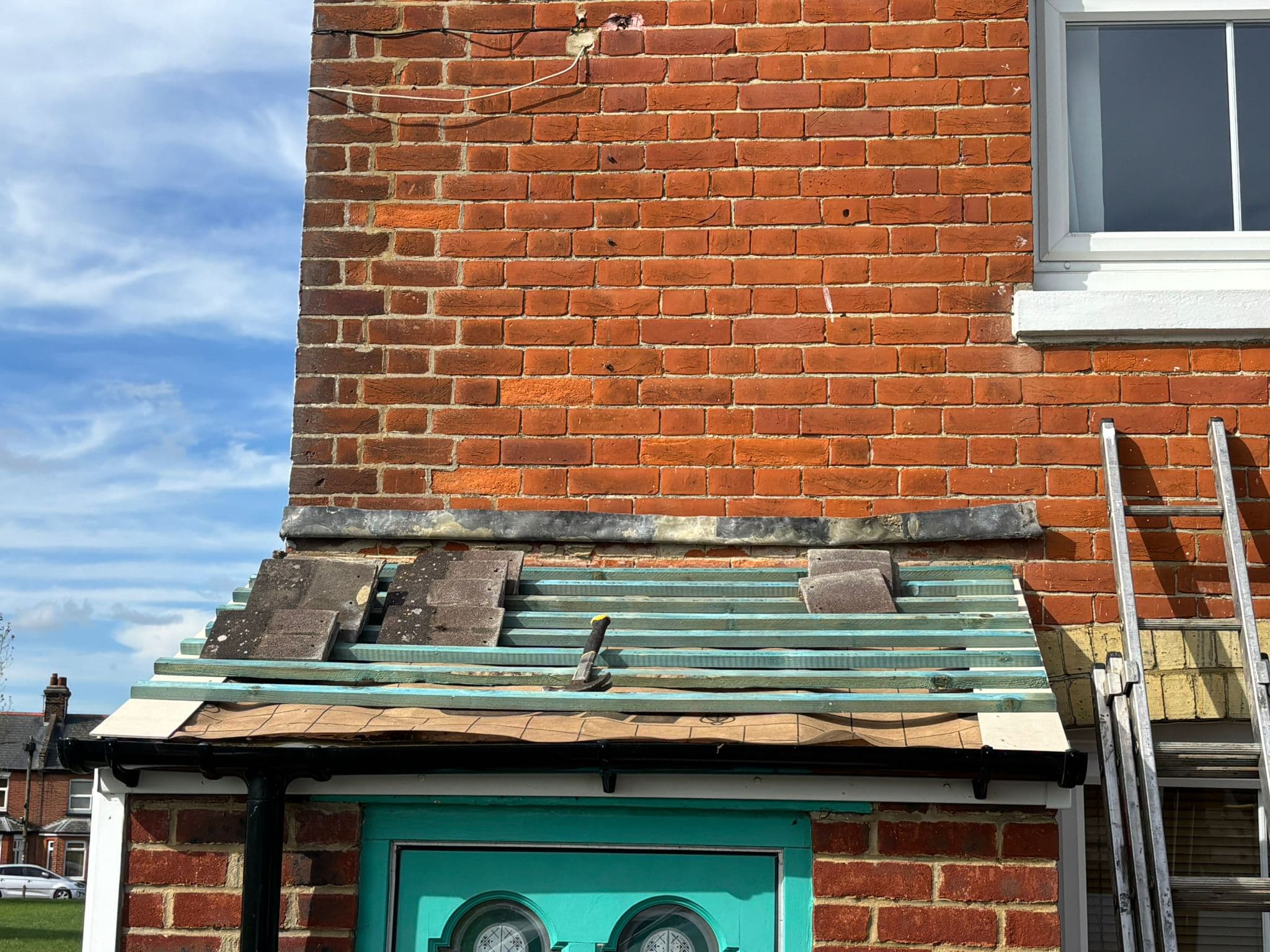 A brick cottage in Dover with the roof stripped back for repair