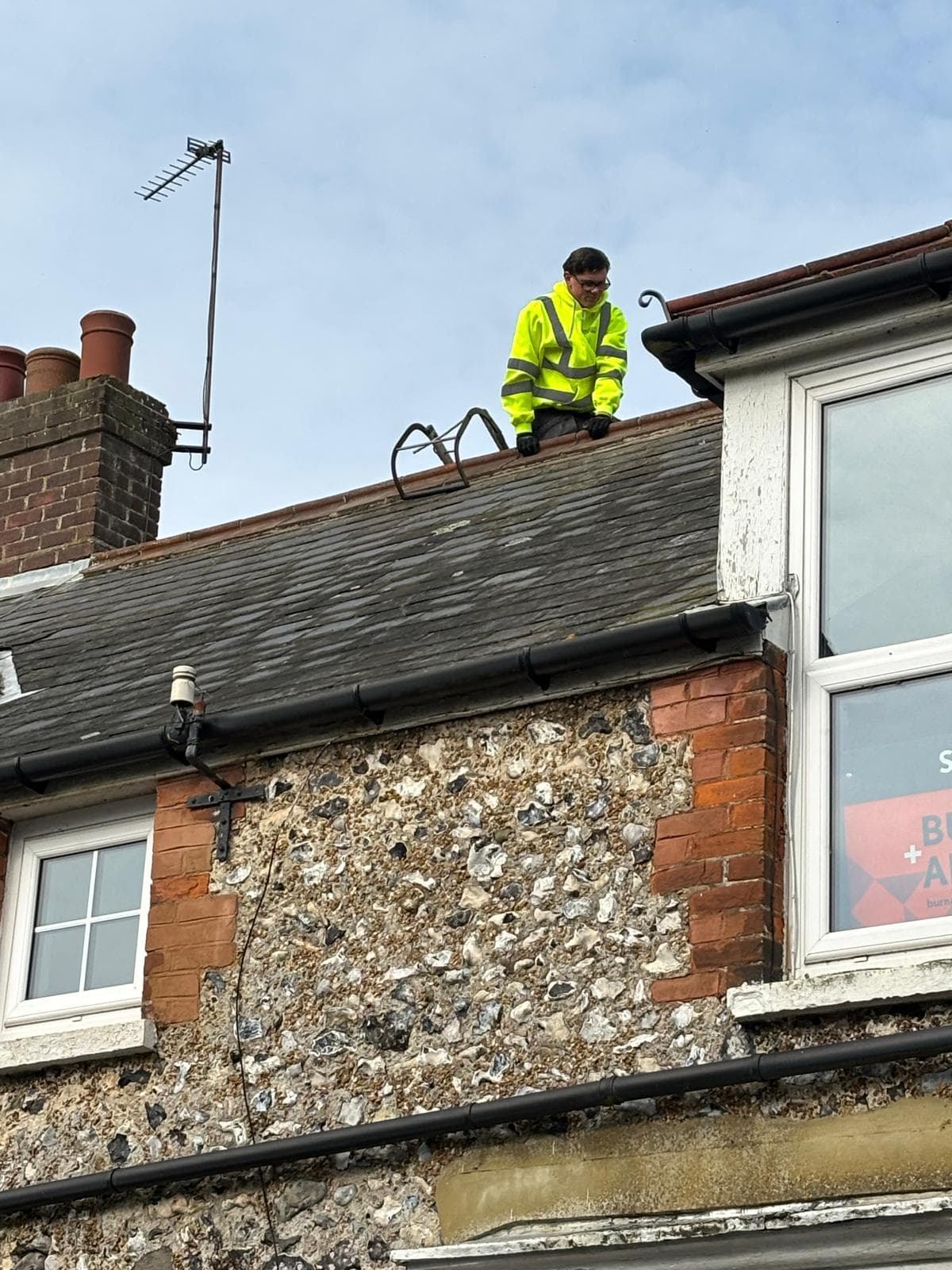 Fascia and soffit repair under way on a flint cottage in Kent