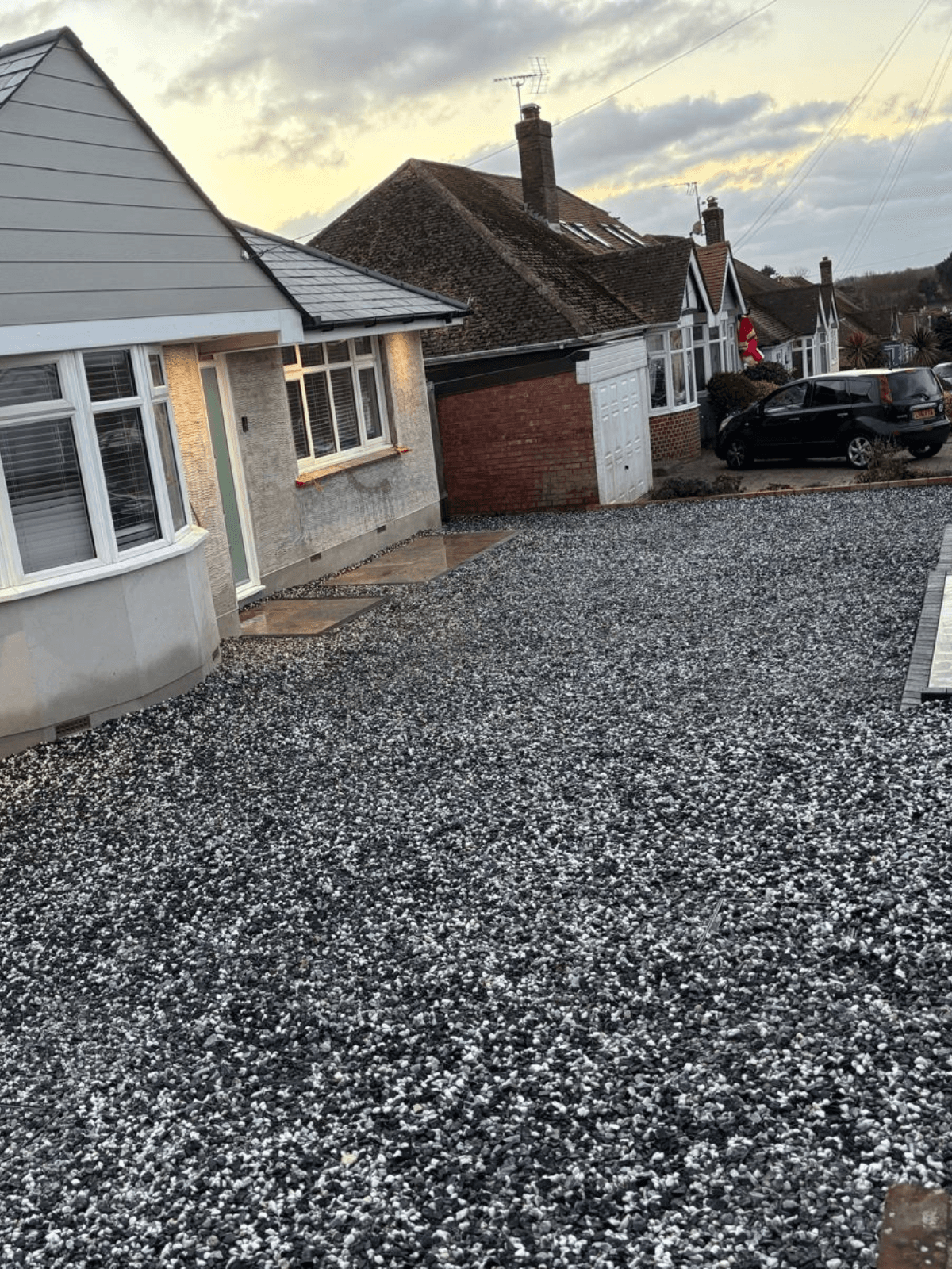 A finished resin driveway laid beside a house in Kent