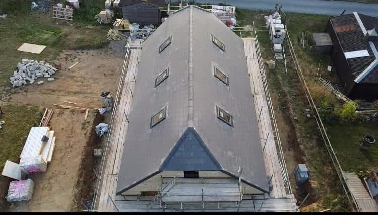 A long tiled roof ridge photographed from above during a survey