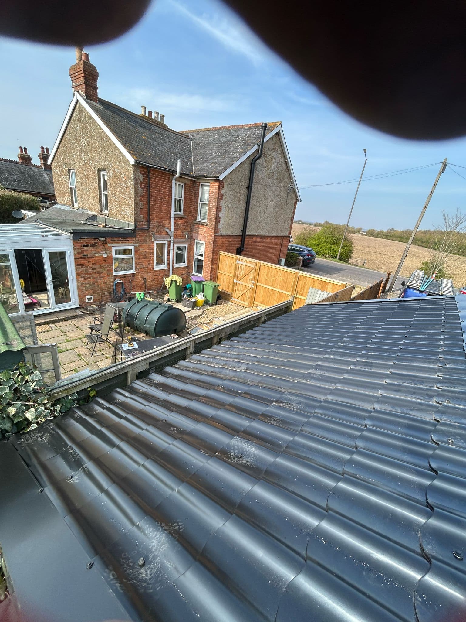 A new dark tiled roof on a house in Kent