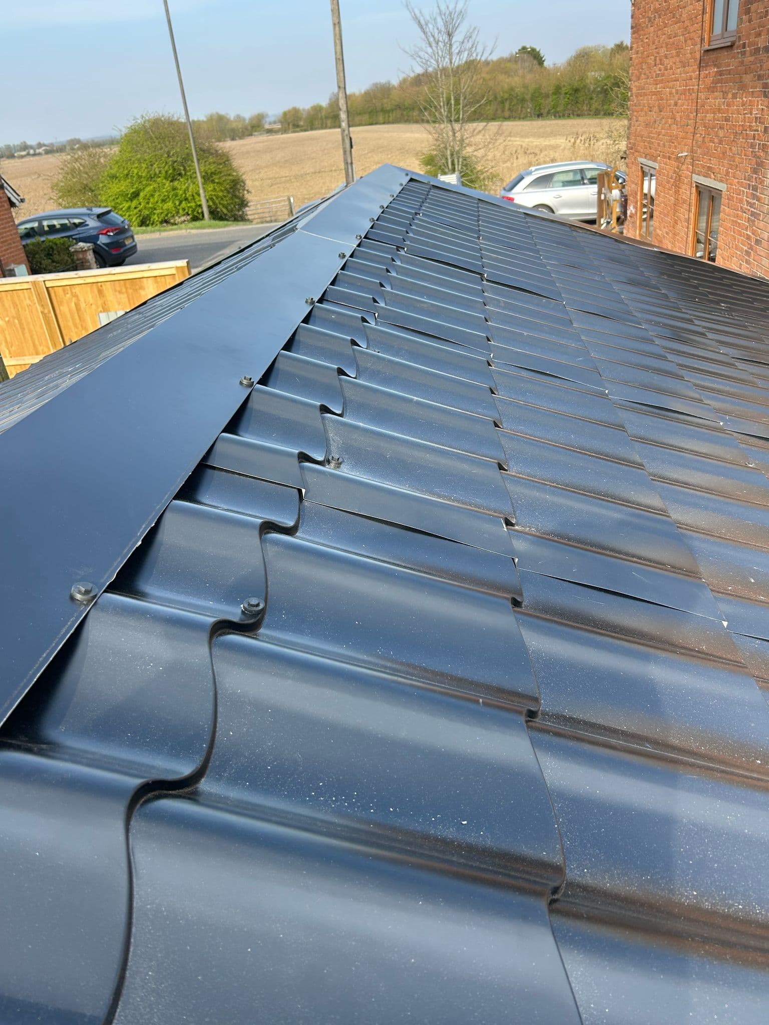 A newly installed dark tiled roof on a house in Kent